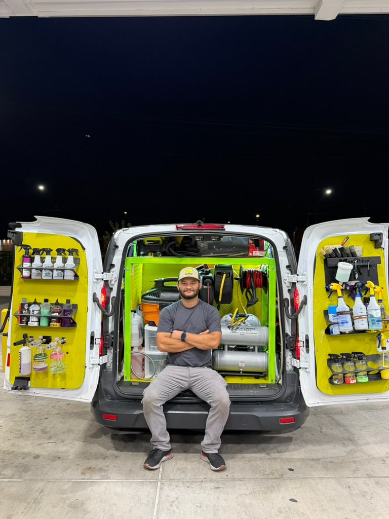 Ronny sitting in his mobile detailing van with his equipment and supplies